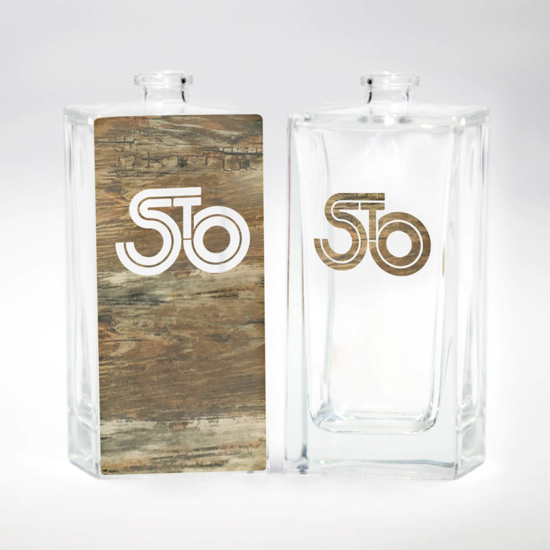 Two decorated perfume bottles in wood optic