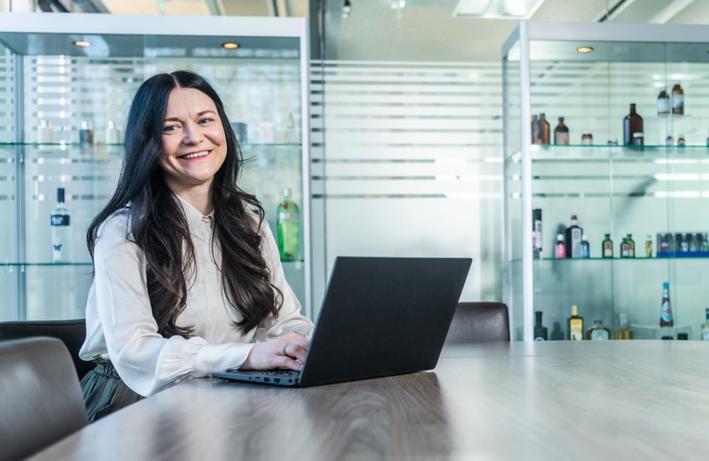 Sales representative sitting at the table with a laptop