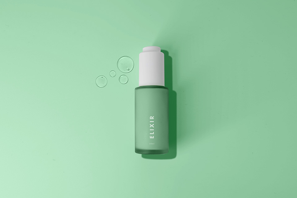 Elixir bottle on green background