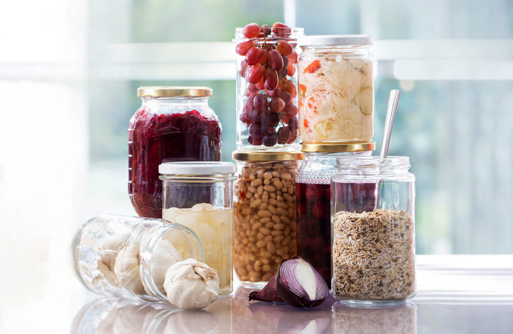 Selection of glass jars filled with some deliciuos food products