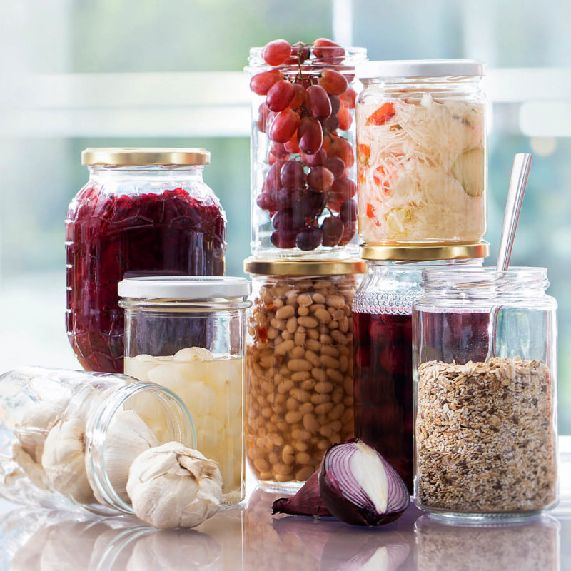 Selection of glass jars filled with some deliciuos food products