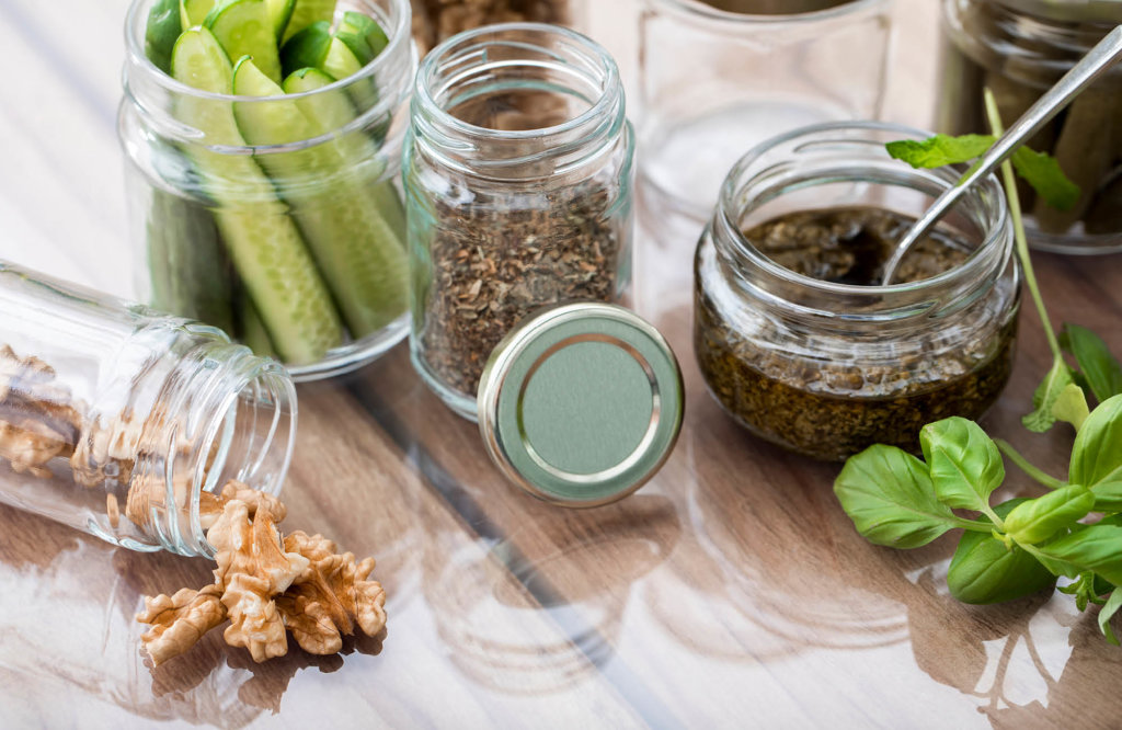 Top view of glass jars filled with different green food products