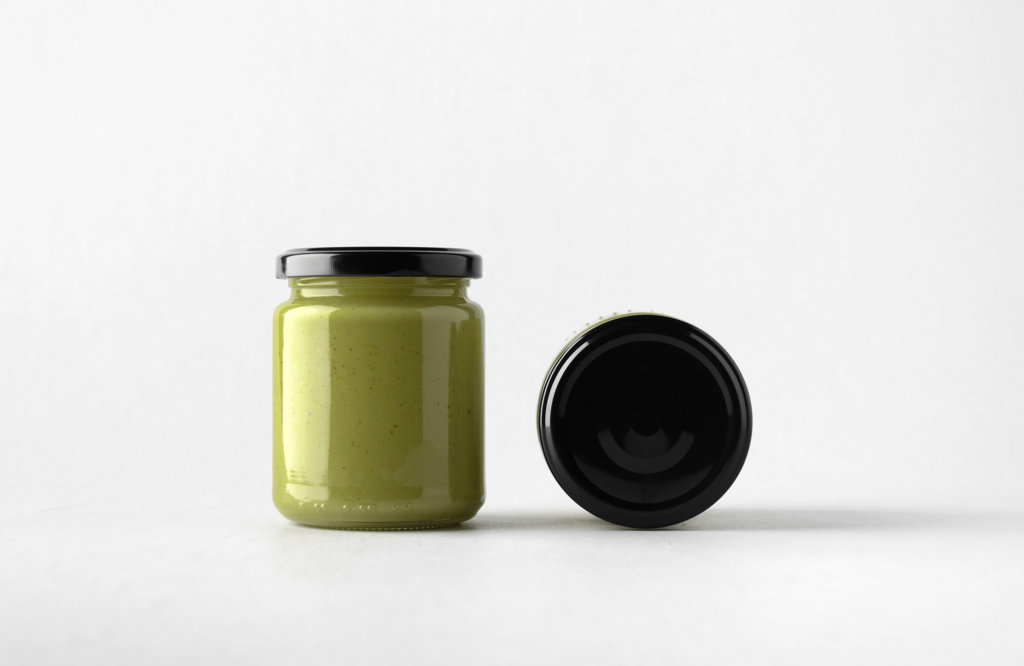 Glass jar with black closure filled with Pumpkin Seed Butter
