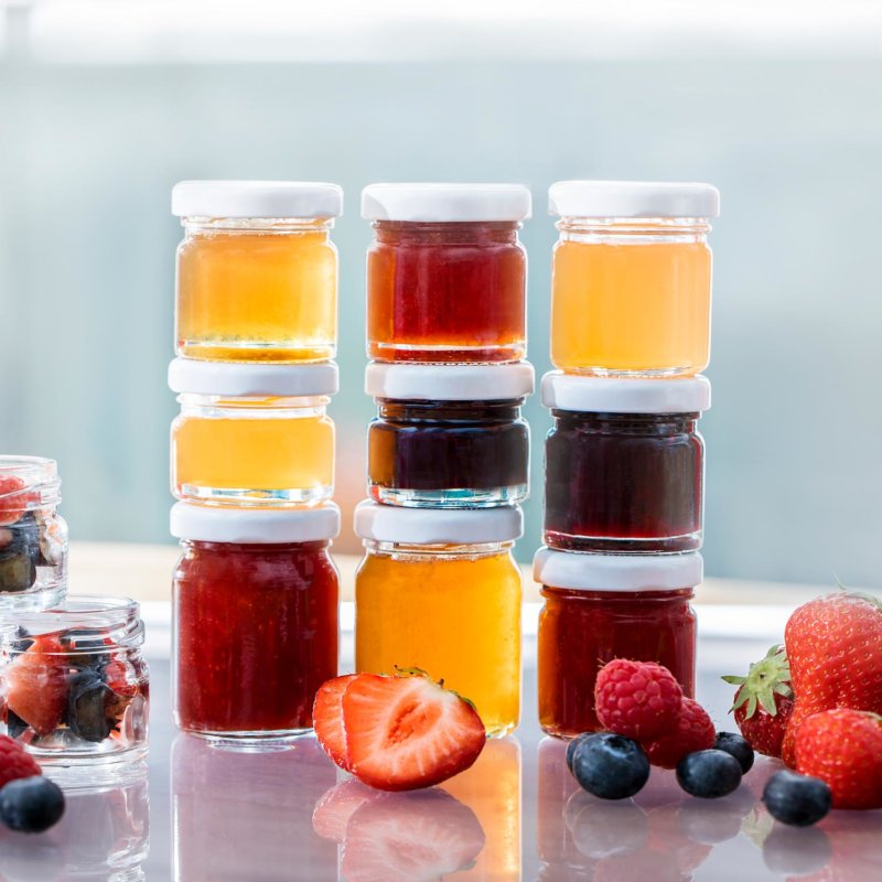 Filled Mini jam jars with suitable closures in fruit setting