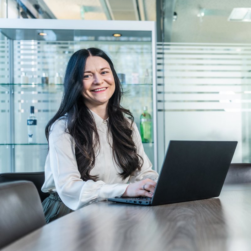 Sales representative sitting at the table with a laptop