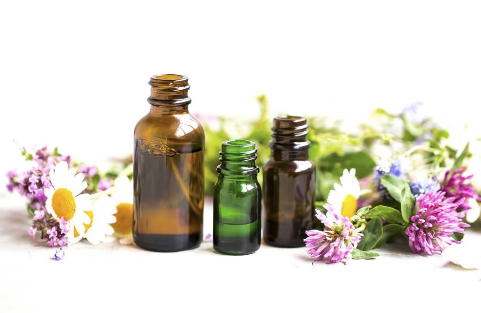 Pharma Glass bottles for essential oils and cbd with herbs and flowers in background