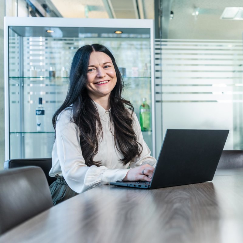 Sales representative sitting at the table with a laptop