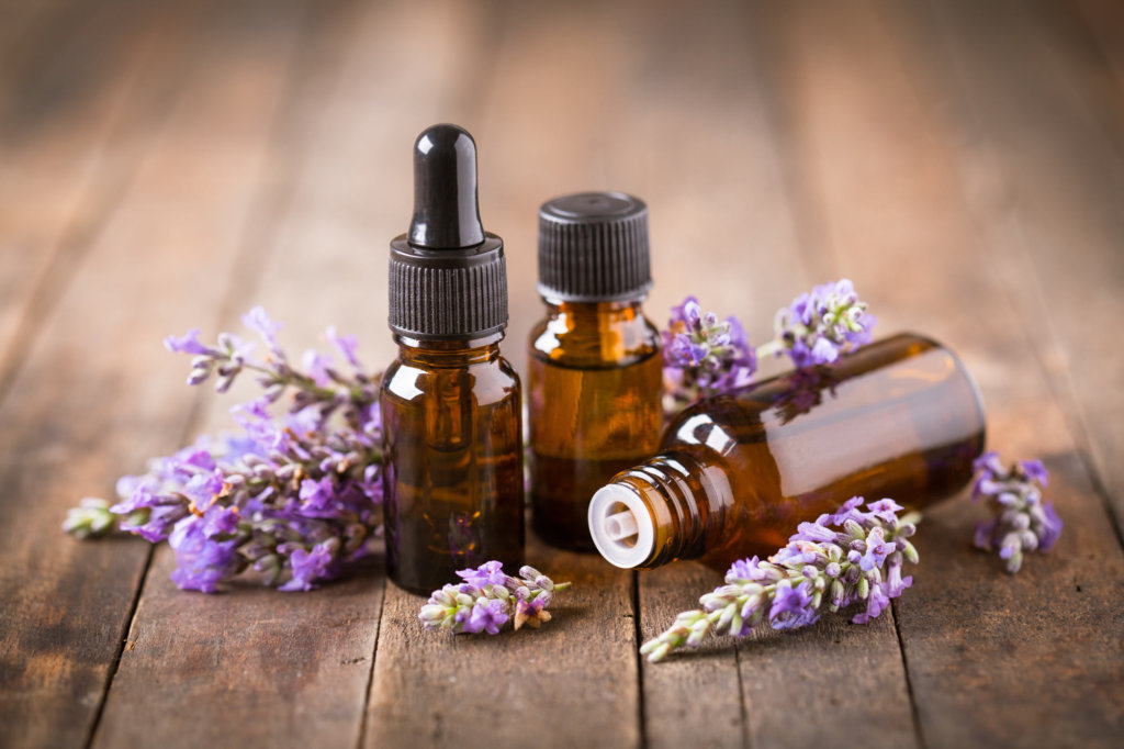 Essential oils on wooden table with Lavender