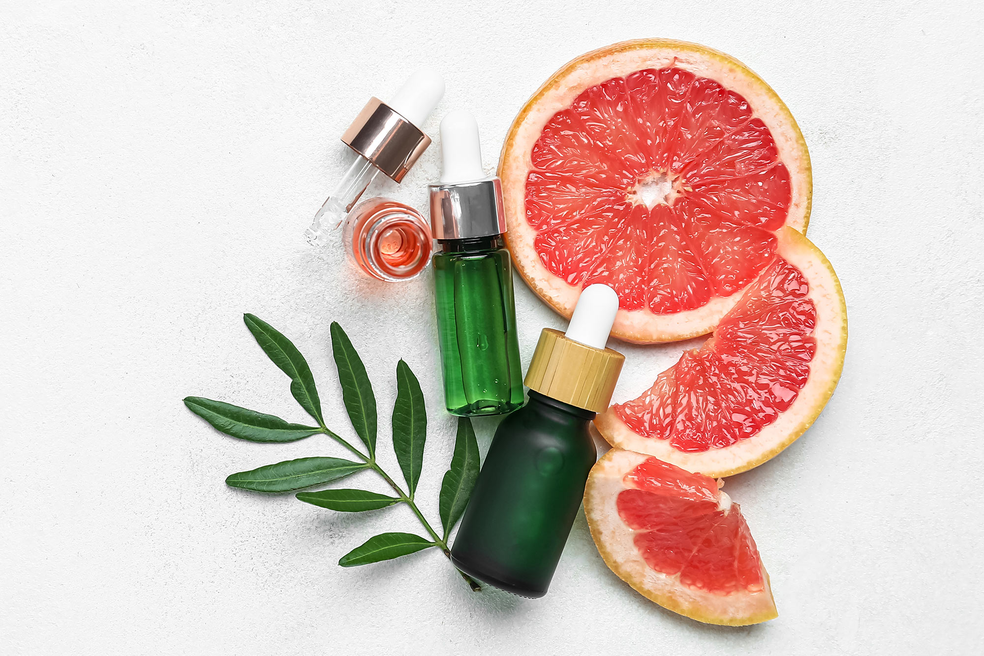 Essential oil bottles with closures and orange pieces