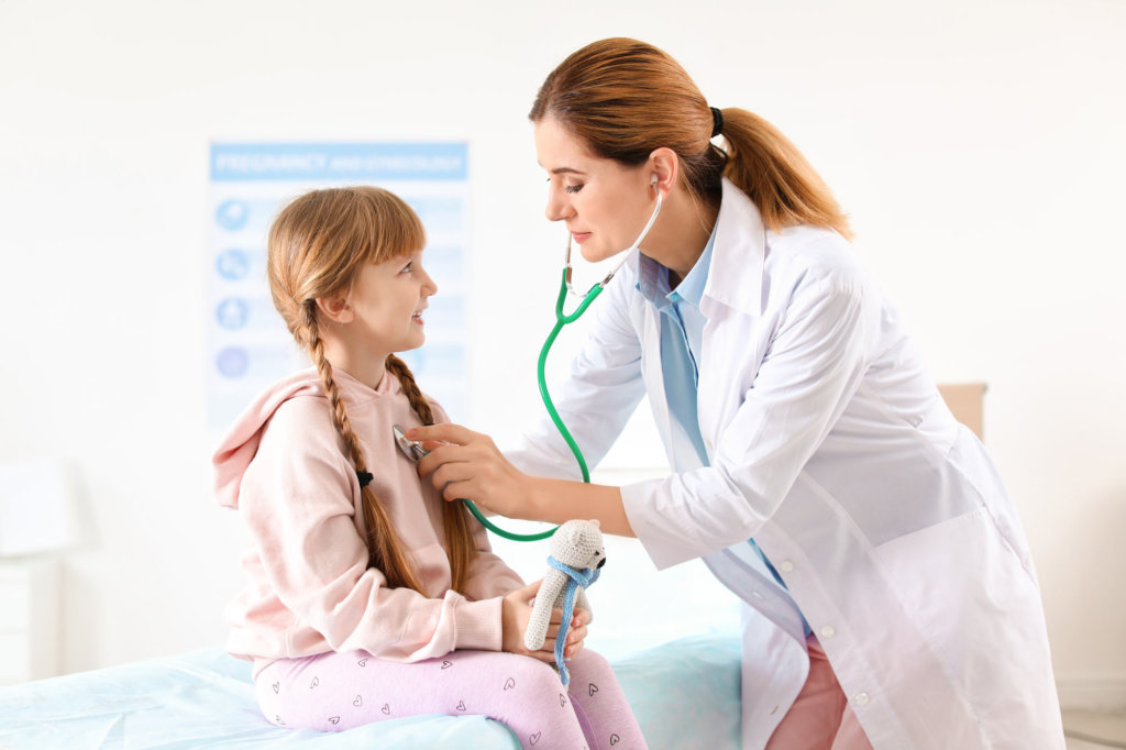 doctor examines child