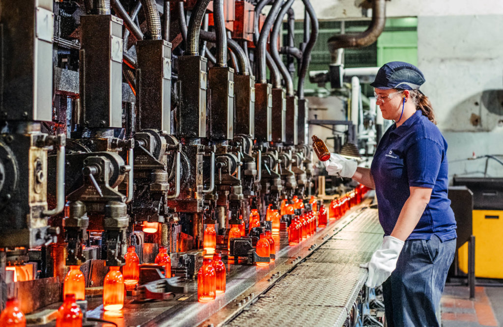 Female machine oprator at the production line
