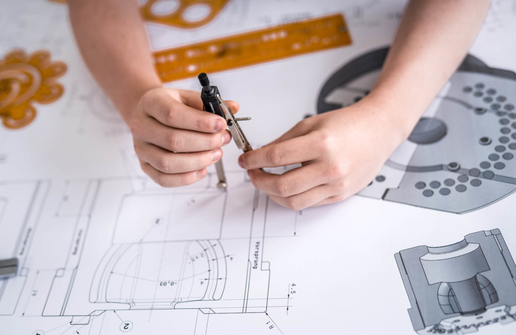 Technical drawing and hands of a person doing modifications