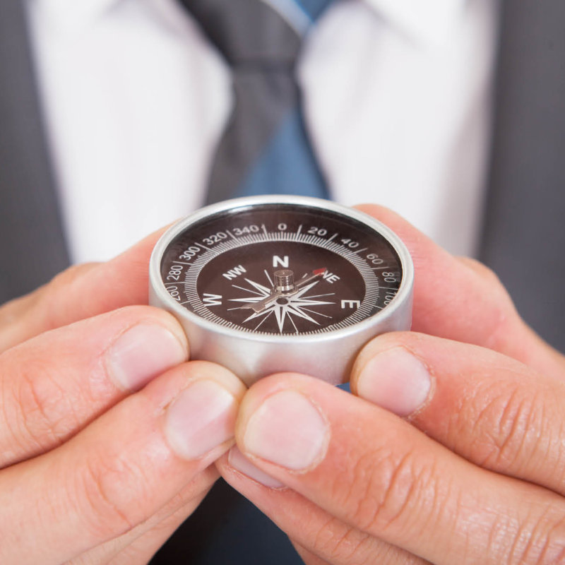 Hand holding compass