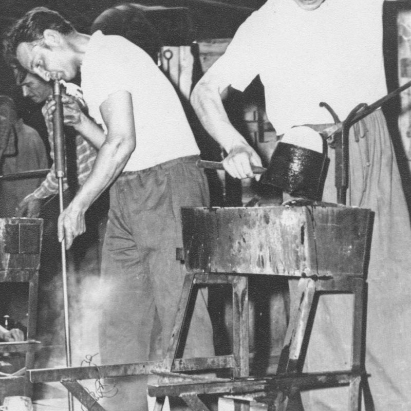 Historic picture of glassmakers producing mouth blown glassware