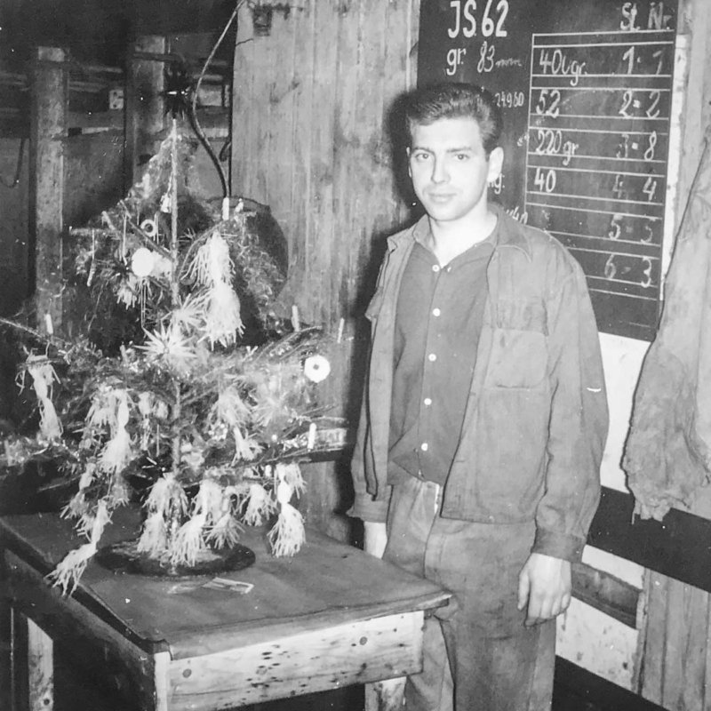 Historic picture of of employee beside Christmas tree in the Austrian plant