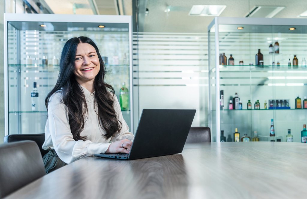 Sales representative sitting at the table with a laptop